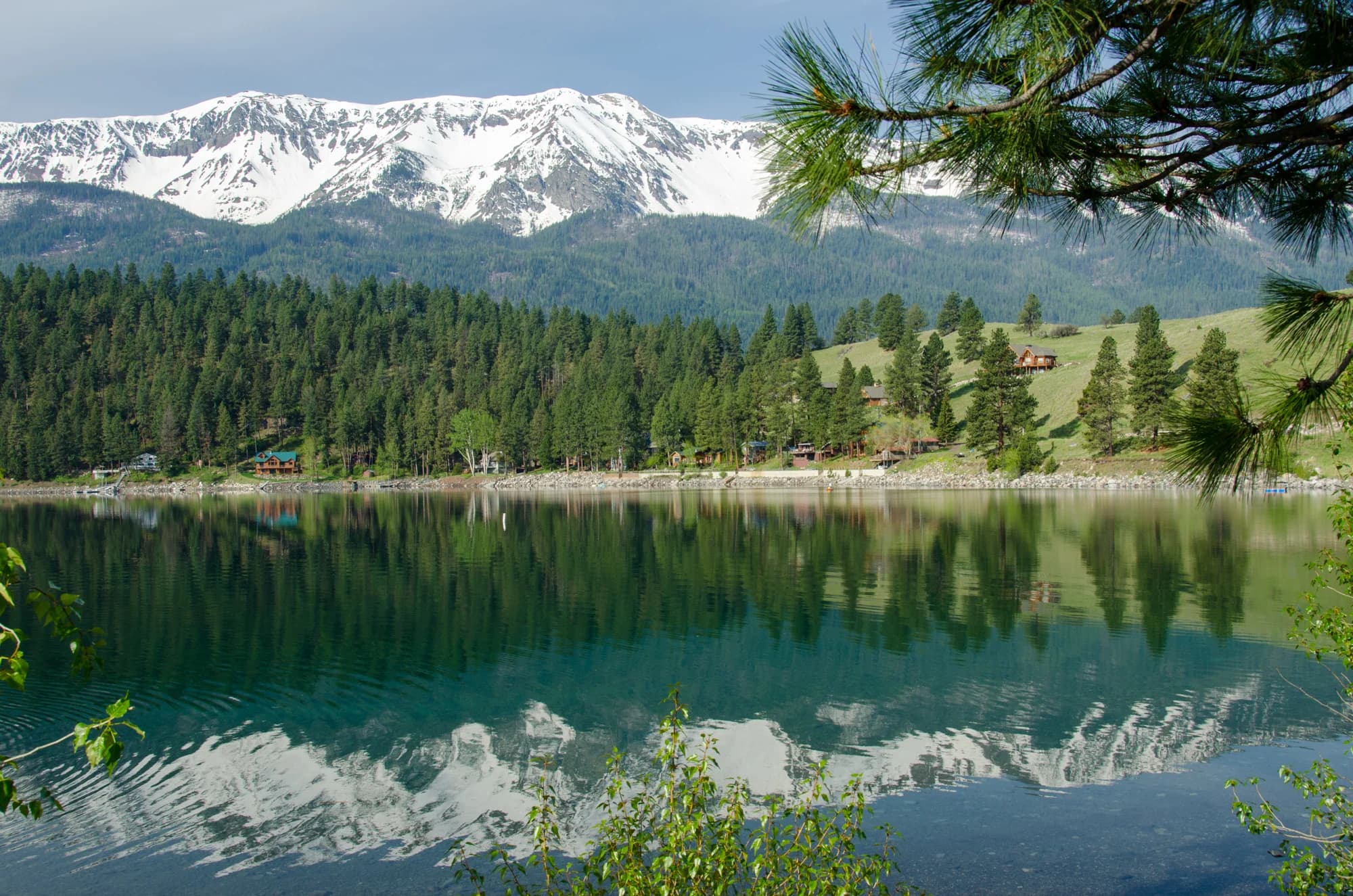 The Wallowa Mountains reflected in the lake, photographed from the north-end county park. This landscape photograph does not depict a particular cultural gathering.
